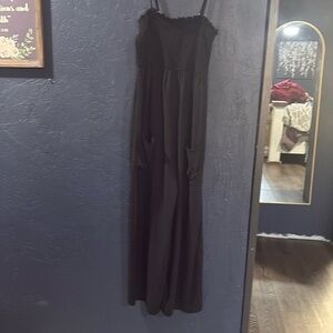 Black spaghetti strap romper with pockets on the front.